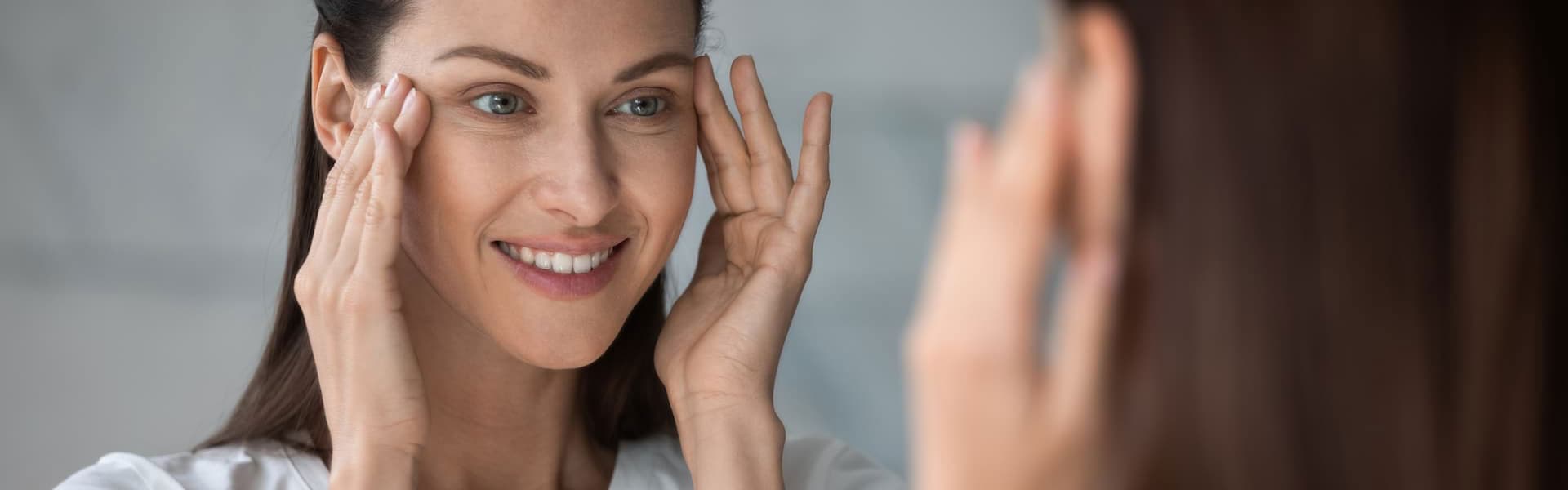 Close-up-head-shot-happy-female-client-satisfied-with-eyes-area-condition