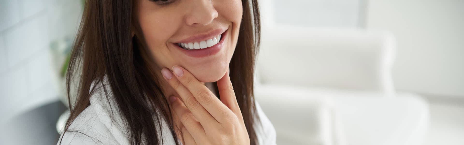 Cropped photo of women holding scultped jaw after chin filler