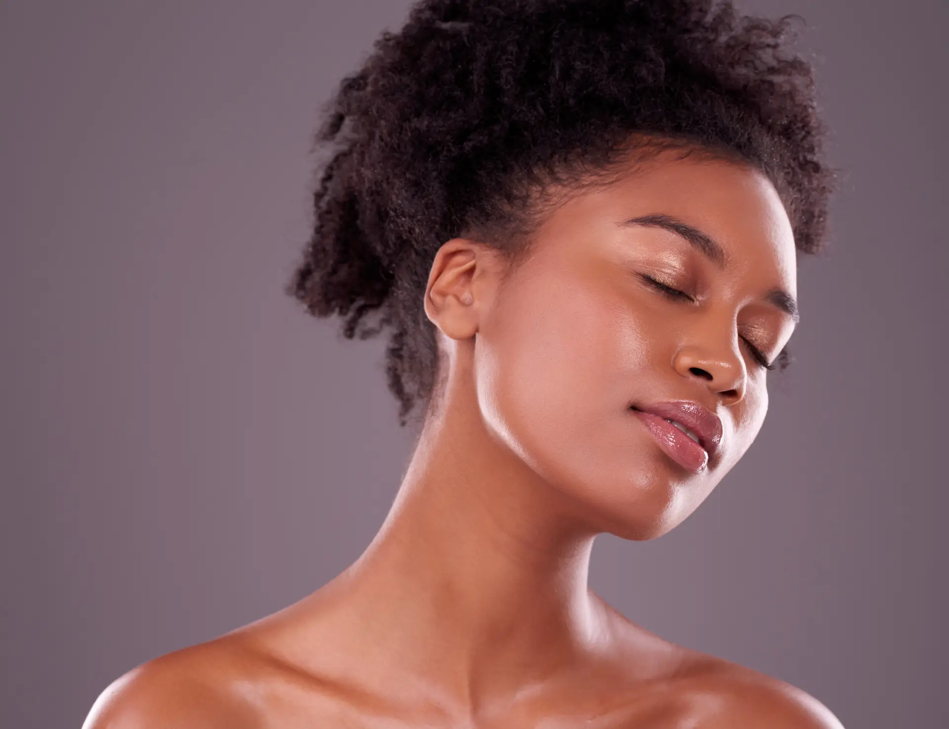 A serene woman with glowing skin and eyes closed, emphasizing wellness and rejuvenation.