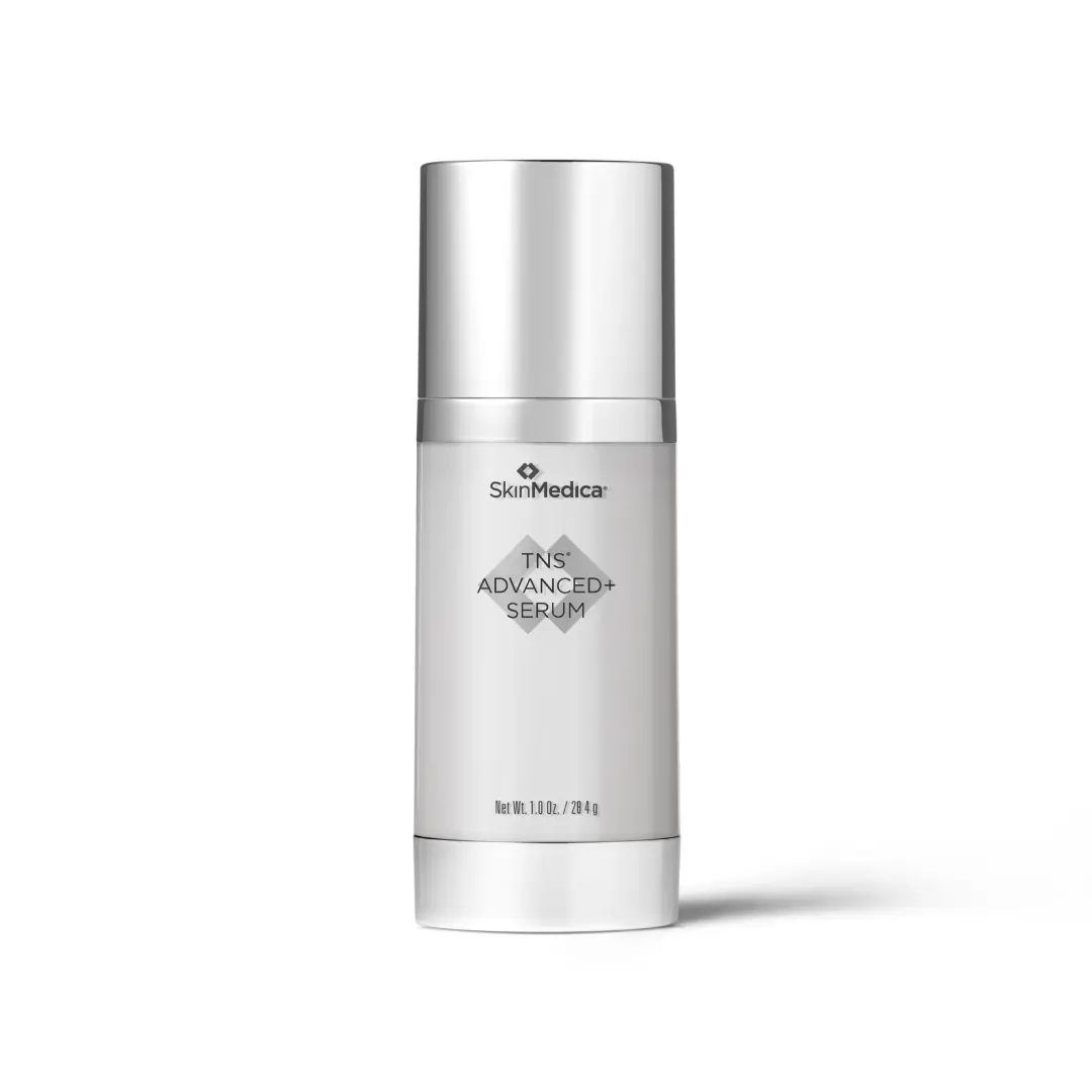 A bottle of SkinMedica TNS Advanced+ Serum with a sleek silver and white design.