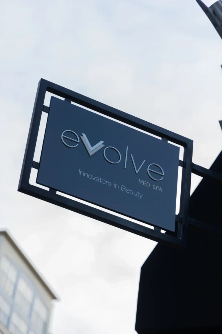 outdoor sign for evolve med spa on brick building