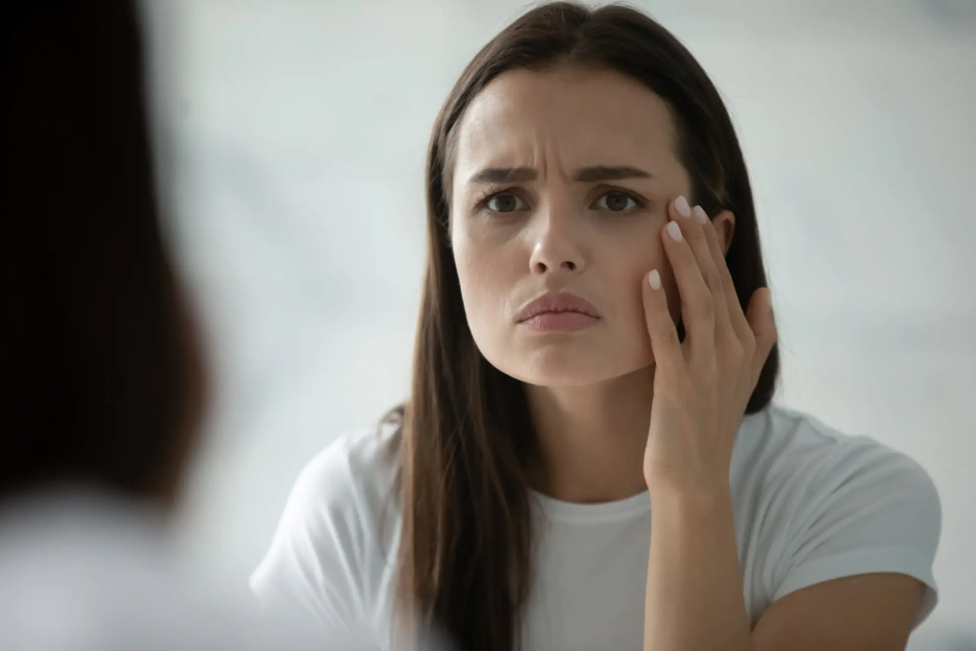 woman looking at wrinkles considering botox treatments