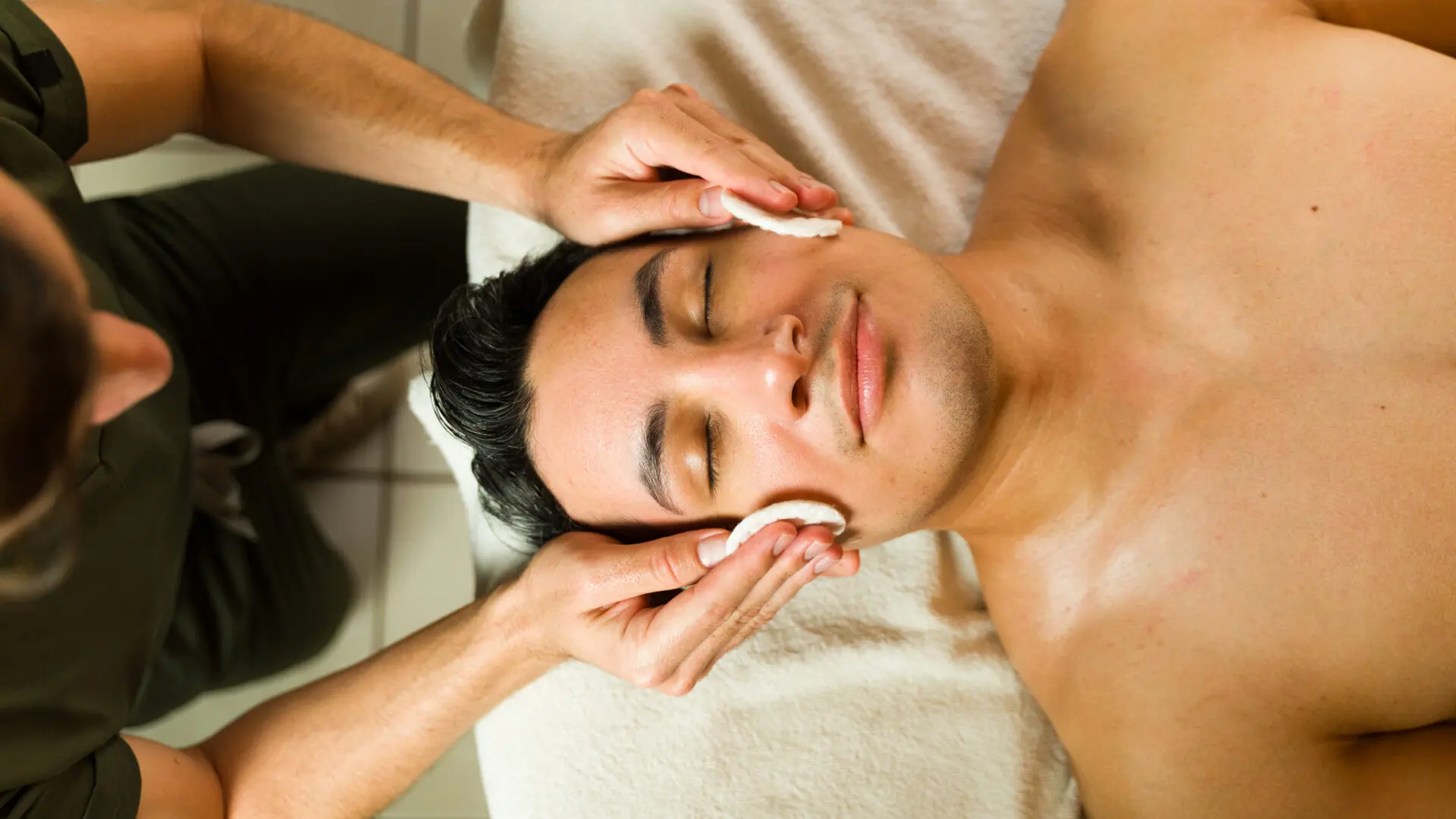 Guy getting facial to help with skin health
